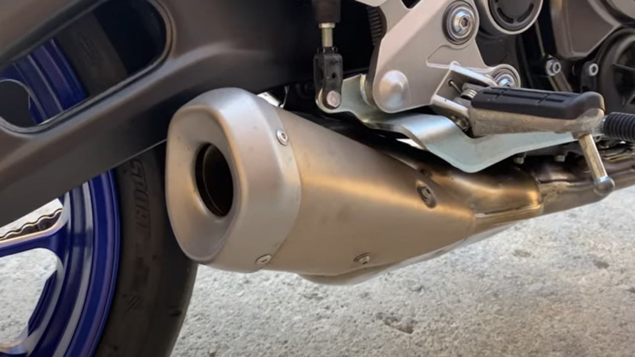 Gently Detach The Old Exhaust Pipe From The Motorcycle
